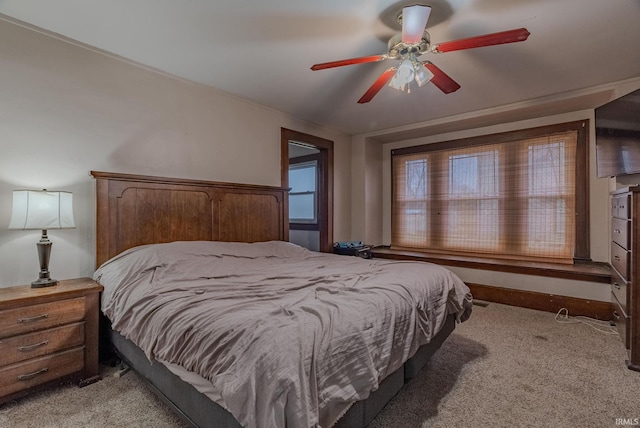 bedroom featuring ceiling fan and light carpet