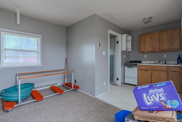 kitchen featuring baseboard heating, sink, and white range with electric stovetop