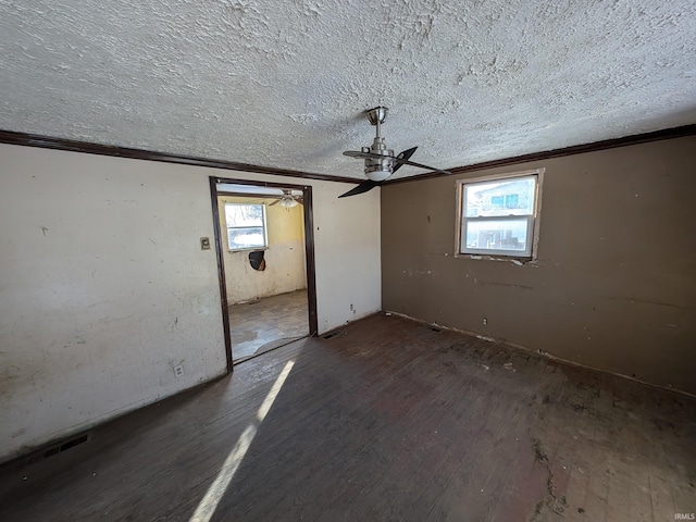 unfurnished bedroom featuring crown molding, dark wood-type flooring, ceiling fan, a textured ceiling, and a closet