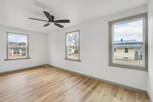 unfurnished room featuring light hardwood / wood-style flooring, plenty of natural light, and ceiling fan