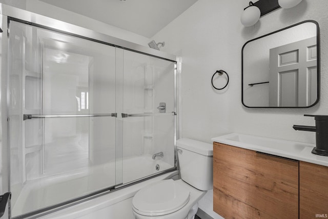 full bathroom featuring vanity, shower / bath combination with glass door, and toilet