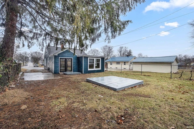 rear view of house with a yard