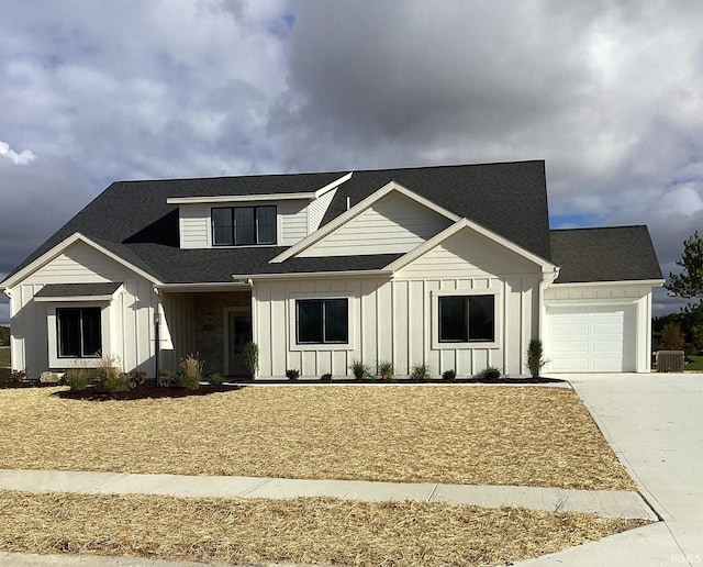 view of front of house with a garage and central AC