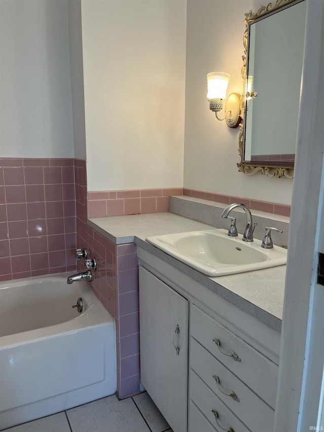 bathroom featuring vanity, a bath, and tile patterned flooring