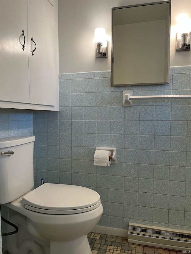 bathroom featuring toilet and tile walls