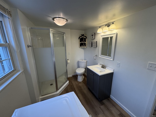 bathroom featuring vanity, hardwood / wood-style floors, an enclosed shower, and toilet