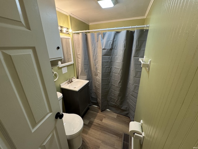 bathroom featuring crown molding, vanity, toilet, and hardwood / wood-style flooring