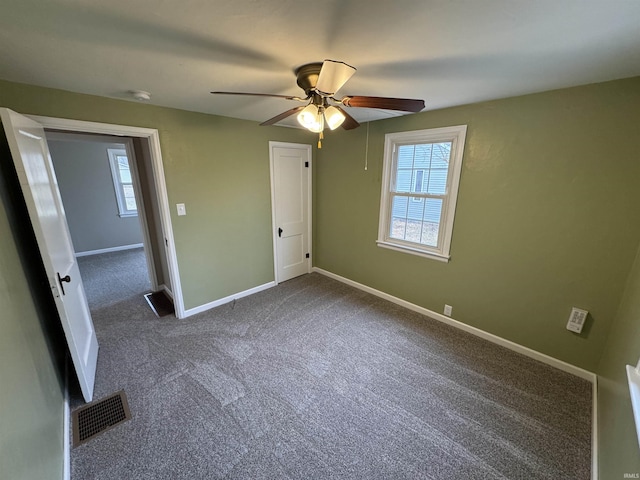 unfurnished bedroom with ceiling fan, carpet floors, and multiple windows