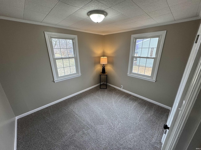 empty room featuring crown molding, carpet, and plenty of natural light