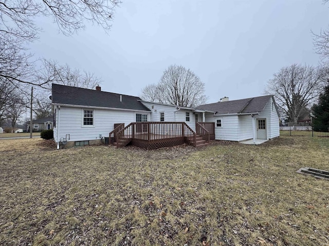 back of house with a wooden deck and a yard