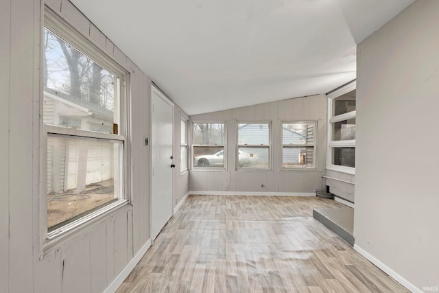 unfurnished sunroom with lofted ceiling and a healthy amount of sunlight