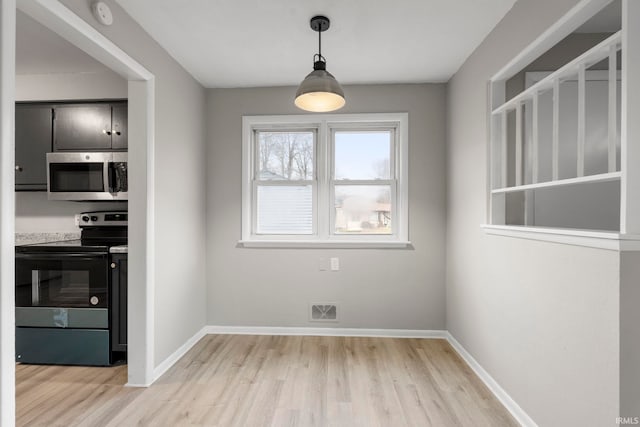 unfurnished dining area with light hardwood / wood-style floors