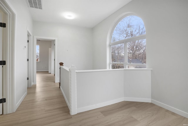 hall with light hardwood / wood-style floors