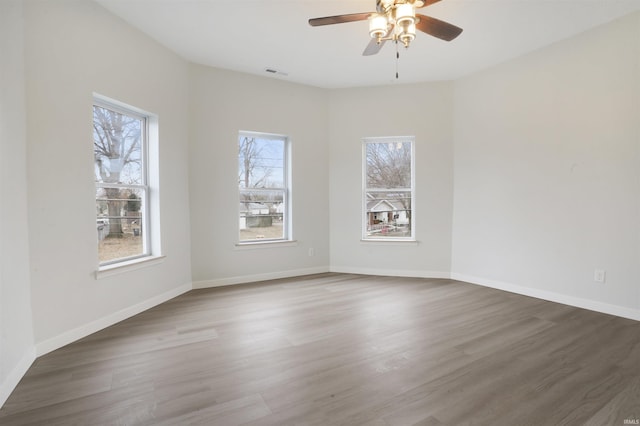 empty room featuring dark wood-type flooring and ceiling fan