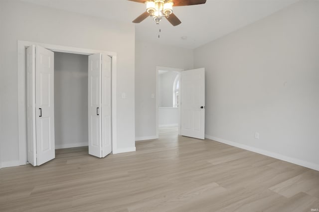 unfurnished bedroom with ceiling fan, a closet, and light hardwood / wood-style flooring