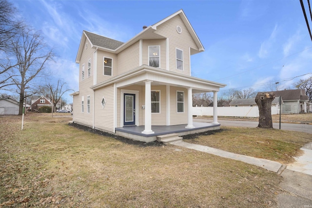 view of front of home with a front yard and a porch