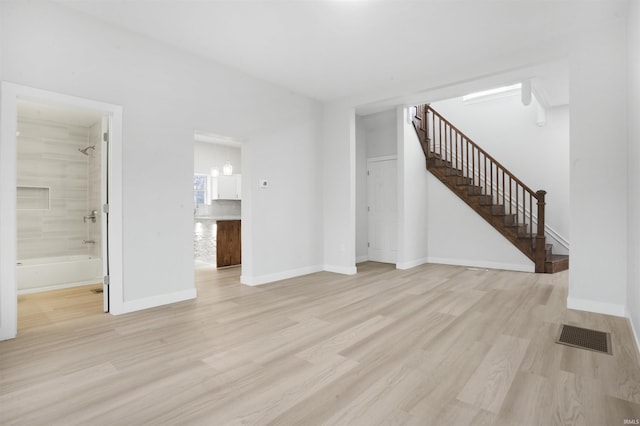 unfurnished living room featuring light hardwood / wood-style floors