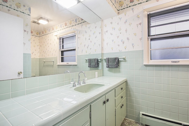 bathroom featuring baseboard heating, vanity, and tile walls