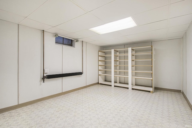 basement featuring a paneled ceiling