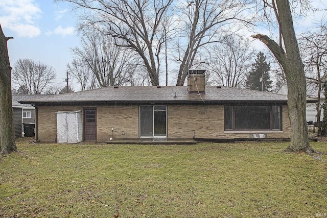 rear view of property featuring a yard