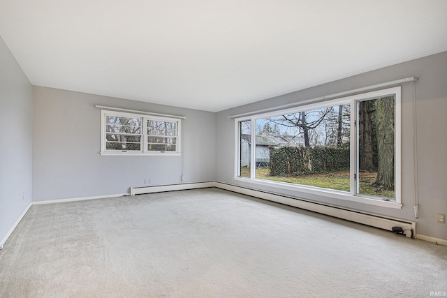 carpeted spare room featuring a baseboard heating unit