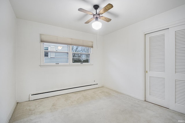 unfurnished bedroom with light colored carpet, a closet, ceiling fan, and baseboard heating