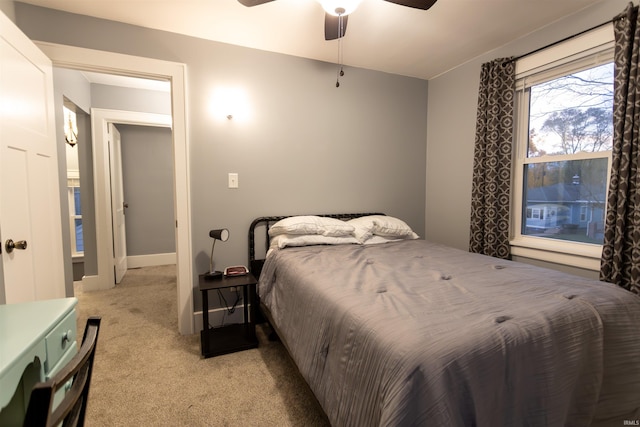 bedroom with light colored carpet and ceiling fan