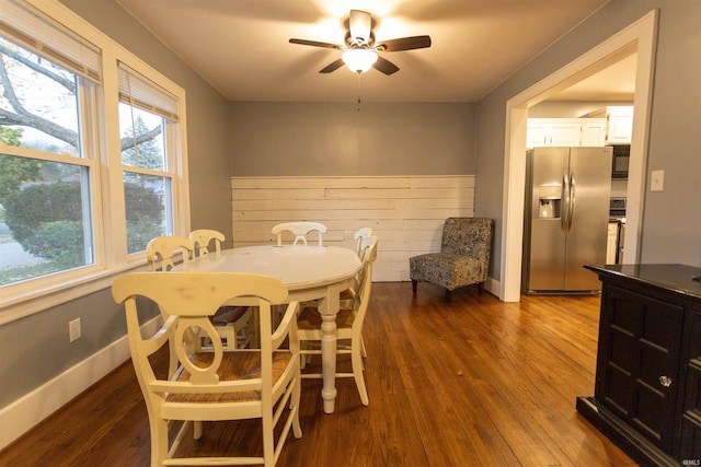 dining space featuring ceiling fan and dark hardwood / wood-style floors