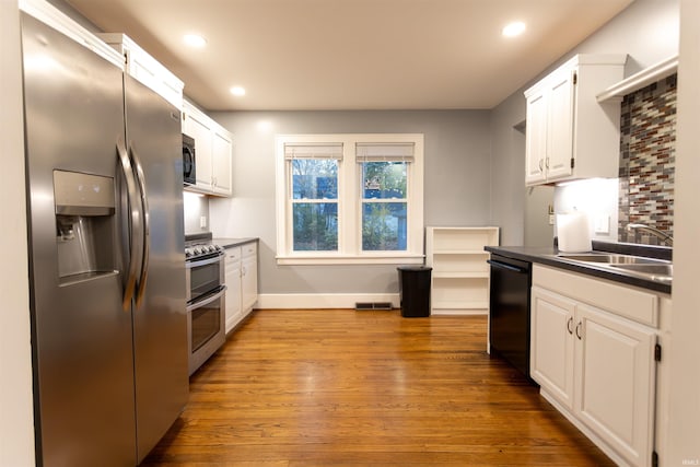 kitchen featuring white cabinetry, sink, light hardwood / wood-style flooring, and black appliances