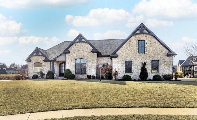 french country style house featuring a front lawn