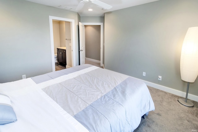 bedroom with ensuite bath, ceiling fan, and carpet flooring