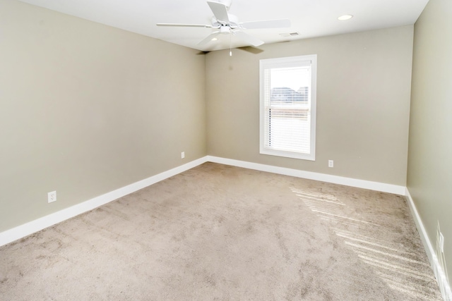 empty room with ceiling fan and carpet