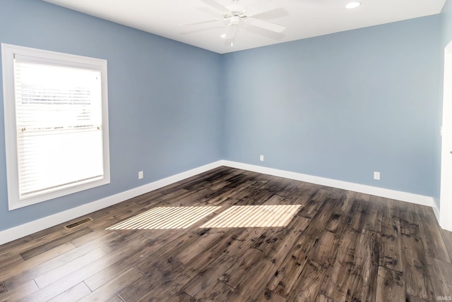 unfurnished room with dark hardwood / wood-style floors and ceiling fan