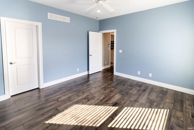 unfurnished room featuring dark hardwood / wood-style floors and ceiling fan