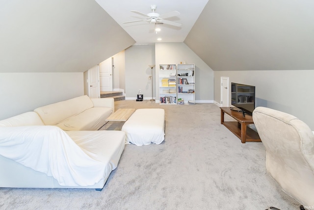 carpeted living room with vaulted ceiling and ceiling fan