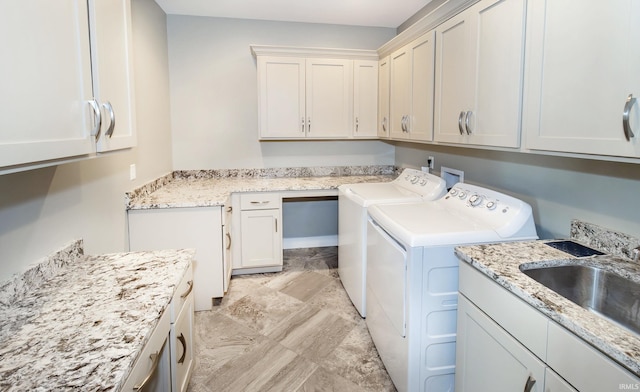 washroom featuring independent washer and dryer, cabinets, and sink