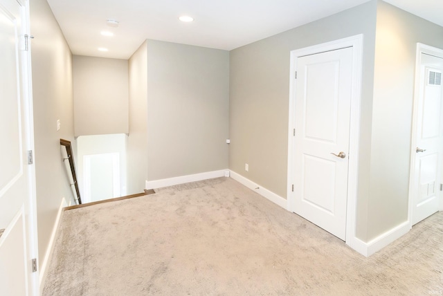 empty room featuring light colored carpet