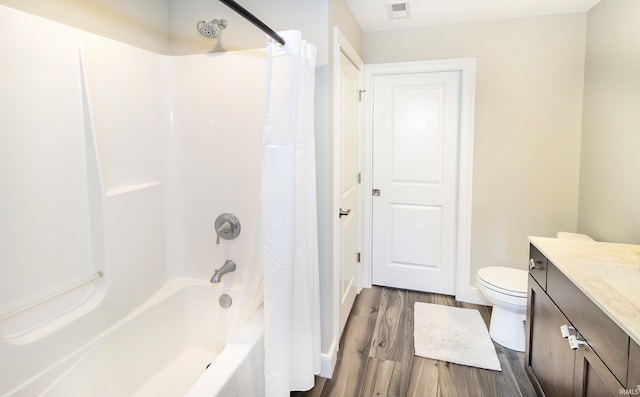 full bathroom featuring shower / bathtub combination with curtain, vanity, hardwood / wood-style flooring, and toilet