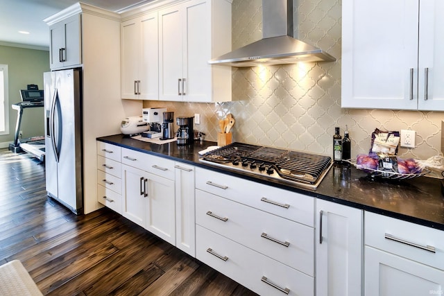 kitchen with stainless steel appliances, dark hardwood / wood-style floors, white cabinets, and wall chimney exhaust hood