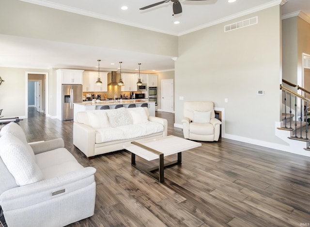 living room featuring dark wood-type flooring, ceiling fan, and crown molding