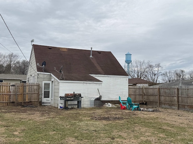 rear view of house with a lawn