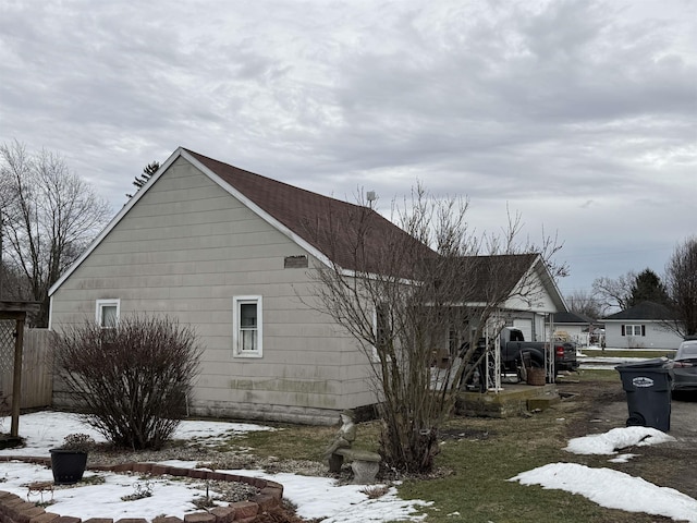 view of snowy exterior with a garage