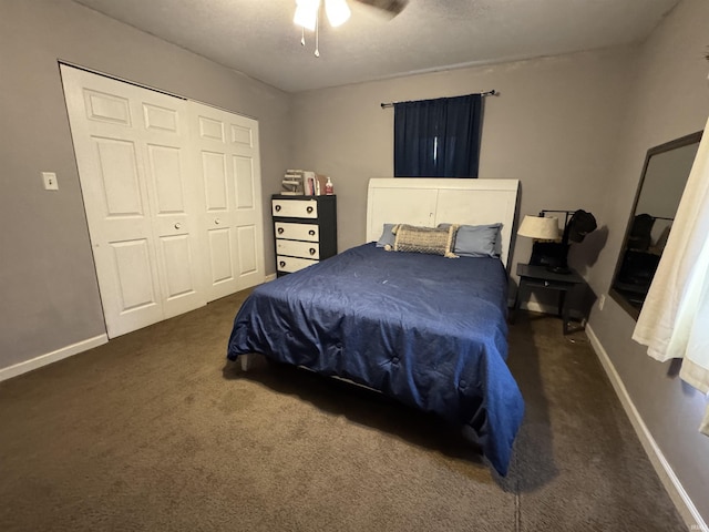 bedroom featuring ceiling fan, dark carpet, and a closet