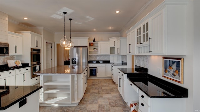 kitchen featuring pendant lighting, white cabinetry, stainless steel appliances, a center island, and dark stone counters