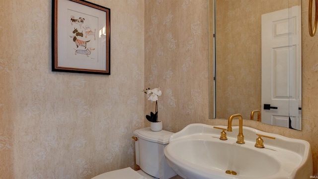 bathroom featuring sink and toilet