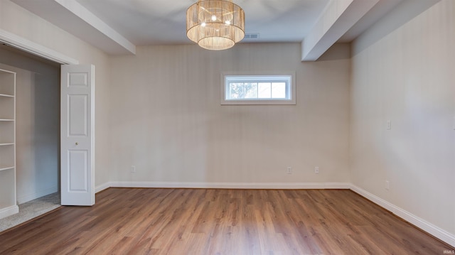 interior space with a notable chandelier and hardwood / wood-style flooring