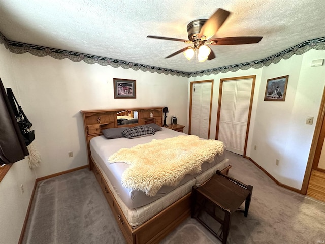 bedroom featuring multiple closets, light colored carpet, and a textured ceiling