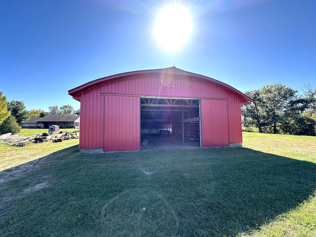 view of outdoor structure with a lawn