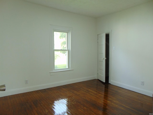 empty room featuring dark wood-type flooring