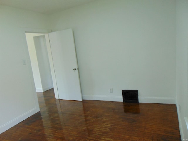 unfurnished room with dark hardwood / wood-style floors